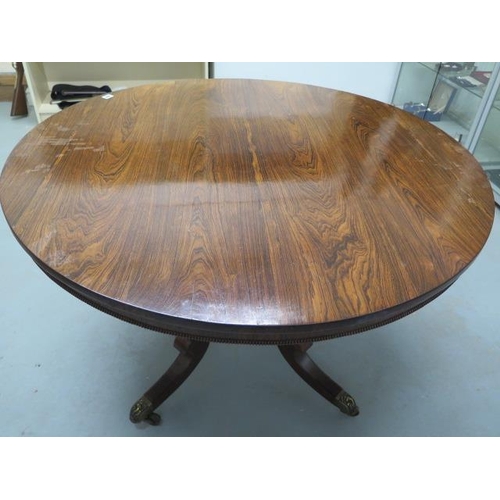 509 - A Regency period rosewood circular tilt top dining table - Diameter 115cm - on four out swept legs w... 