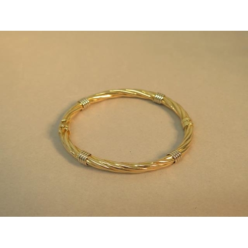 77 - A 9ct bi colour hallmarked bangle/bracelet - 6cm x 5.5cm - sprung hinge, good overall condition - we... 