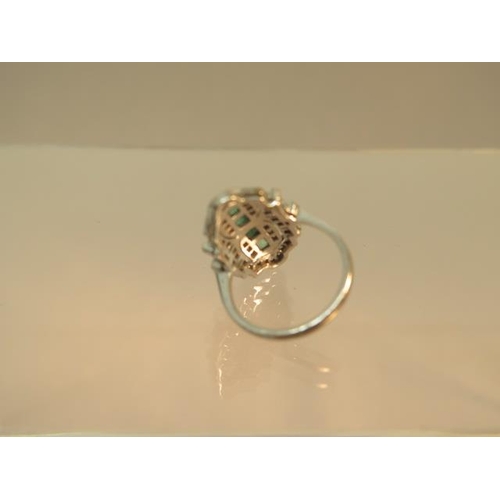 84 - An Art Deco emerald and diamond ring set in platinum (tested) ring size M