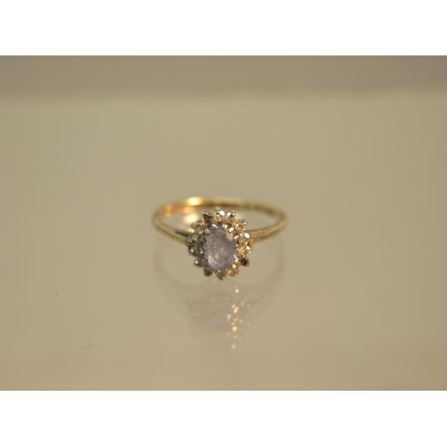 98 - A 9ct hallmarked yellow gold sapphire and diamond cluster ring size J - weight approx 1.4 grams