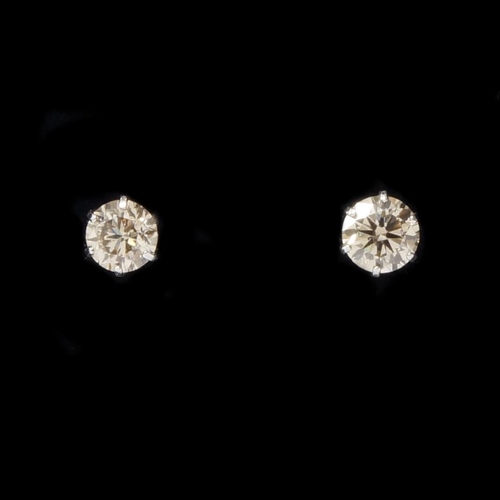 99 - A pair of platinum 6-claw set diamond studs with rubber-capped butterflies, boxed - round brilliant ... 