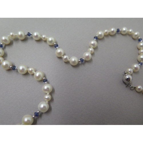 216 - A single string of pearls with cabochon blue sapphires, round pearls of two sizes set in triplet div... 