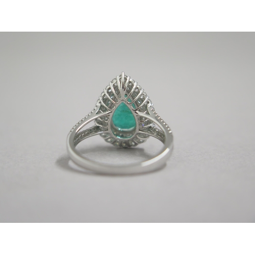 111 - A stunning 18ct white gold (hallmarked) emerald and diamond ring, the central pear shaped emerald ap... 