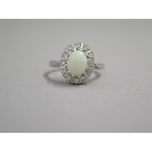 190 - An 18ct white gold opal and diamond ring - head size approx 13mm x 11mm - ring size approx M