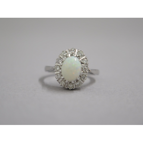 190 - An 18ct white gold opal and diamond ring - head size approx 13mm x 11mm - ring size approx M