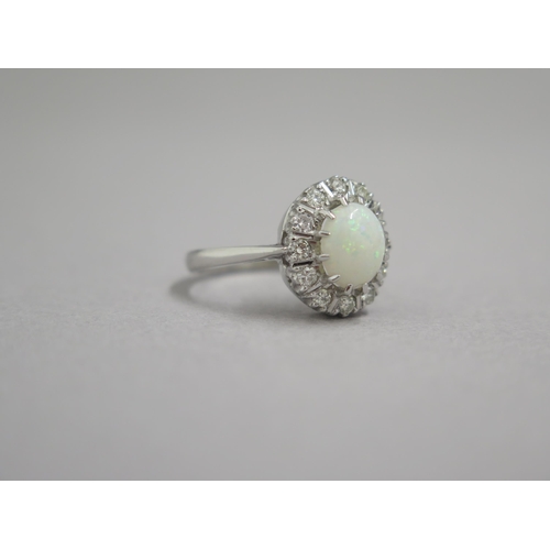 190 - An 18ct white gold opal and diamond ring - head size approx 13mm x 11mm - ring size approx M