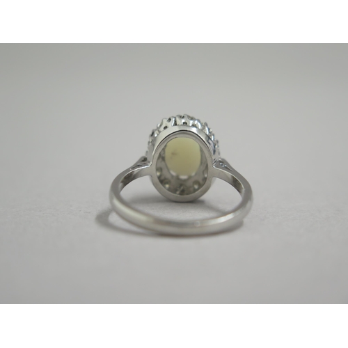 190 - An 18ct white gold opal and diamond ring - head size approx 13mm x 11mm - ring size approx M