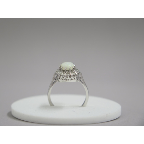 190 - An 18ct white gold opal and diamond ring - head size approx 13mm x 11mm - ring size approx M