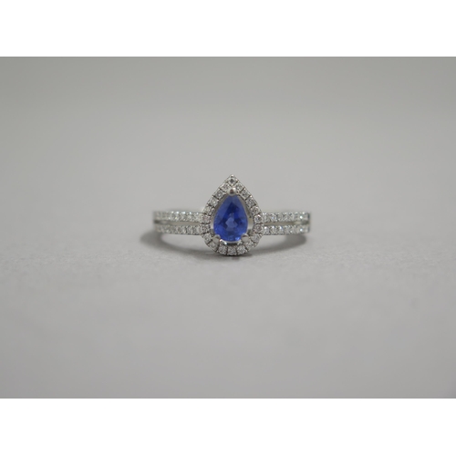 204 - An 18ct white gold pear shaped sapphire and diamond ring, diamonds are well matched and bright and l... 