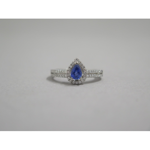 204 - An 18ct white gold pear shaped sapphire and diamond ring, diamonds are well matched and bright and l... 