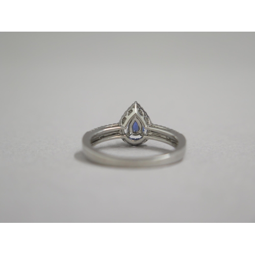 204 - An 18ct white gold pear shaped sapphire and diamond ring, diamonds are well matched and bright and l... 