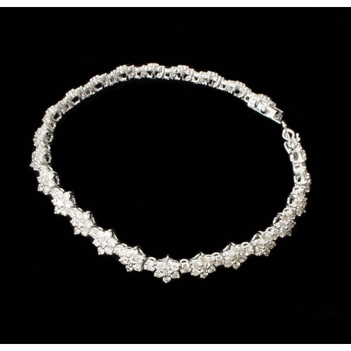 An 18ct white gold daisy-style diamond cluster bracelet, with double safety clasp and box - round brilliant cut diamonds 5.20ct - approx H/I, approx VS2/SI1