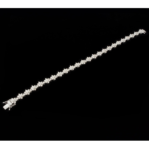 9 - An 18ct white gold daisy-style diamond cluster bracelet, with double safety clasp and box - round br... 