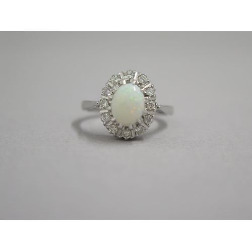 8 - An 18ct white gold opal and diamond ring - head size approx 13mm x 11mm - ring size approx M