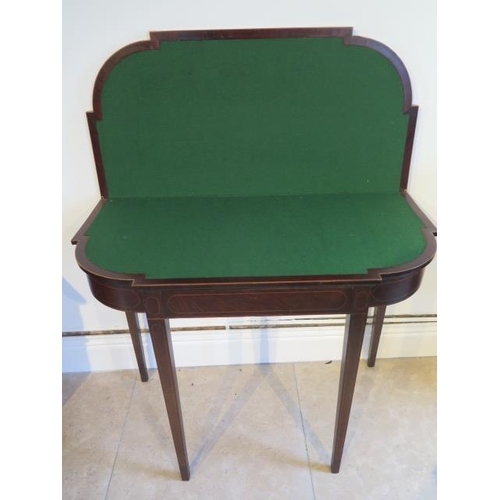 580 - A 19th century mahogany and inlaid fold over card table on square tapering legs - Width 92cm