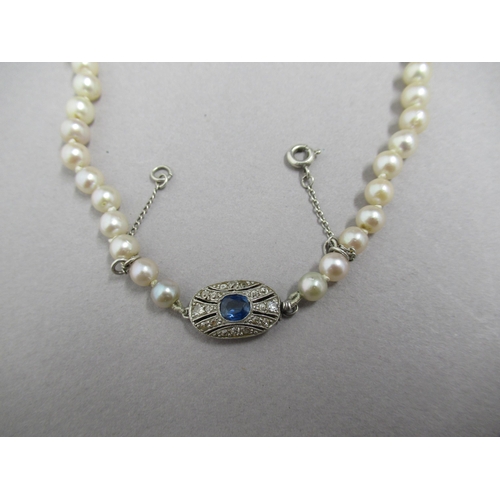 19 - A single string of graduated pearls with 18ct white gold tested sapphire and diamond clasp - approx ... 