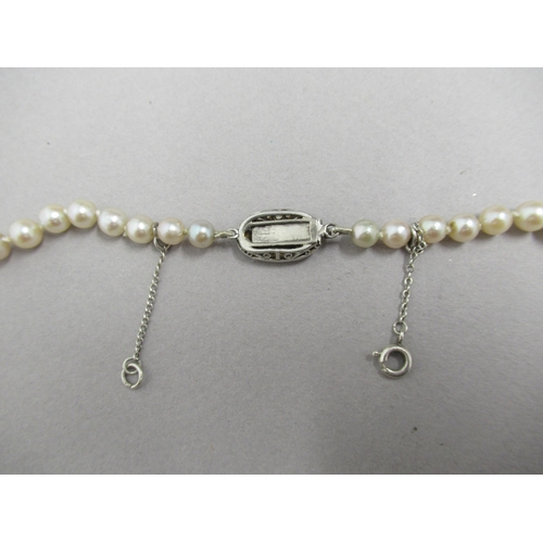 19 - A single string of graduated pearls with 18ct white gold tested sapphire and diamond clasp - approx ... 