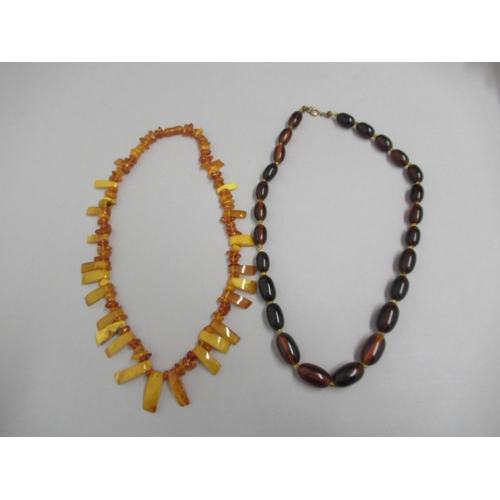 27 - A dark amber graduated bead necklace approx 63cm long, approx weight 69 grams, with a Baltic amber n... 