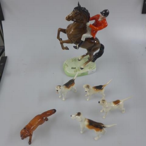 389 - Beswick - mounted fox hunter - 23cm - together with four hounds and fox