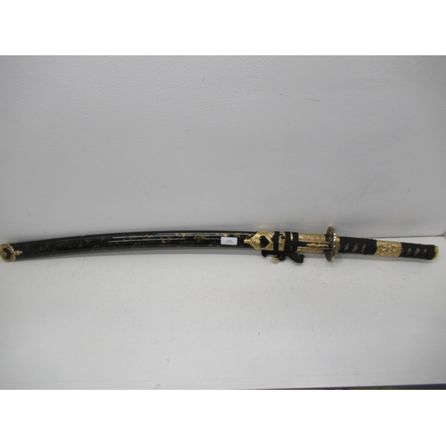 444 - A modern Japanese Katana sword, edged blade approx 70cm with black and gold lacquered gilt metal mou... 