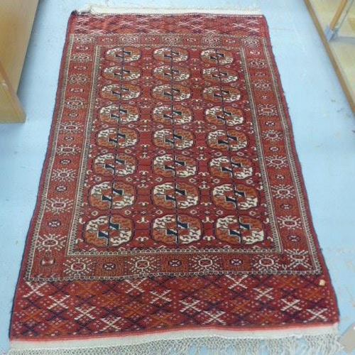 484 - A hand woven woollen rug - 210cm x 127cm