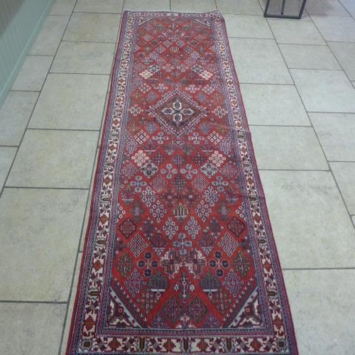 489 - A Meimeh hand knotted woollen rug - 3.98m x 1.05m