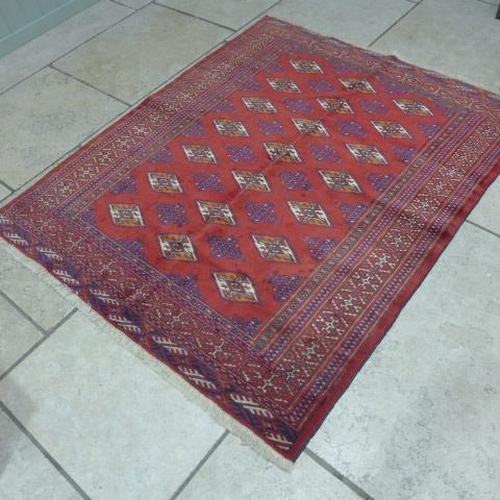 496 - A Turkman hand knotted woollen rug - 1.66m x 1.30m