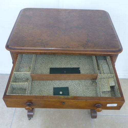 514 - A Victorian burr walnut workbox with a fitted drawer and basket on shaped fretted supports united by... 