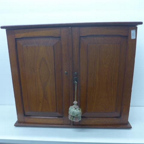 517 - A late 19th/early 20th century walnut cabinet with a fitted interior with drawers and pigeons holes