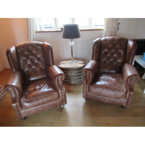 520 - A pair of John Lewis brown leather armchairs