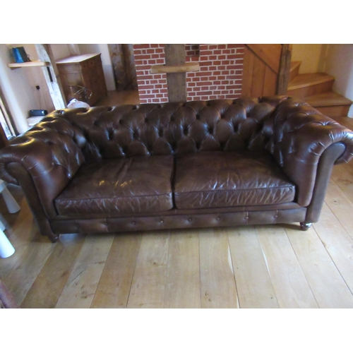 521 - A John Lewis brown leather Chesterfield sofa - as new - 210cm wide