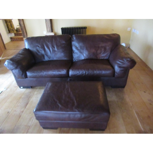 528 - A John Lewis leather sofa and foot stool - in very good condition - Width 220cm