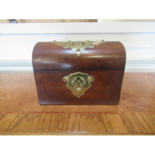 568 - A walnut and brass mounted dome top tea caddy - 18cm x 10cm x 13cm - good overall condition