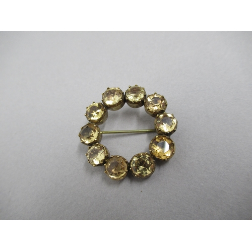 67 - A 9ct yellow gold (tested) and citrine circular brooch - 3cm - approx weight 9.4 grams