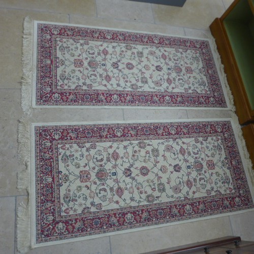 497 - A pair of Belgium rugs - 65cm x 135cm