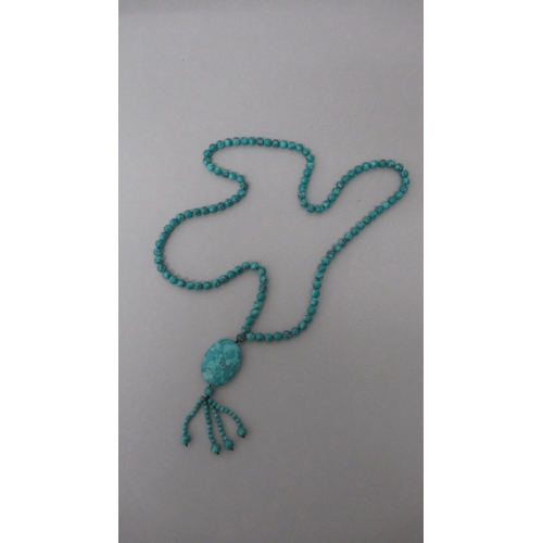 184 - A string of natural turquoise beads with a drop pendant - beads approx 8mm diameter x 86cm long, dro... 