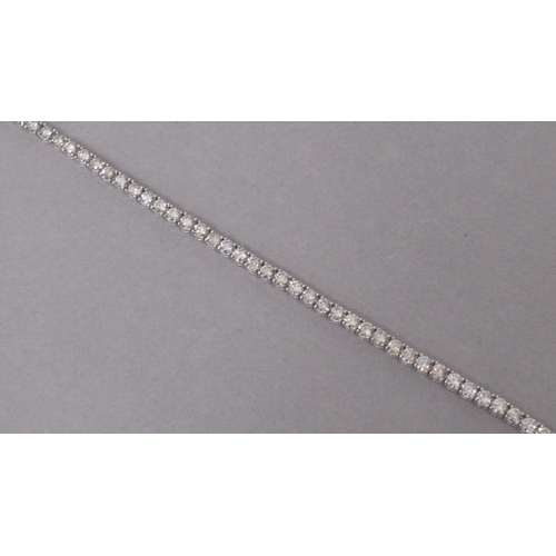 20A - A certificated platinum line bracelet claw-set with round brilliant cut diamonds, with double safety... 