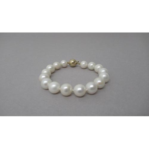 5 - A white cultured pearl bracelet with a 9ct yellow gold ball clasp