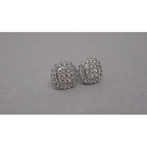 81 - A pair of 14ct white gold rounded square diamond cluster studs, boxed - round brilliant cut diamonds... 