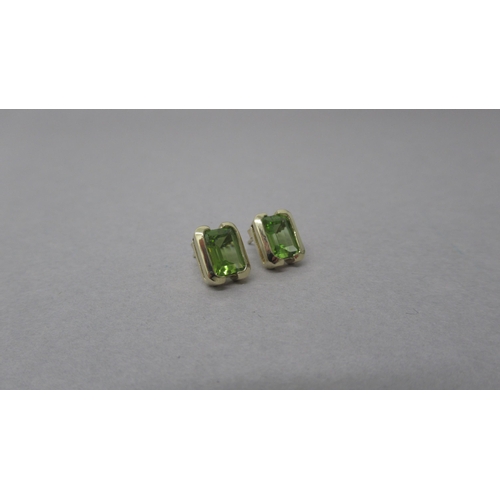 83 - A pair of 9ct yellow gold peridot earrings - peridots are well matched - total weight of peridots ap... 