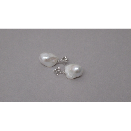 91 - A pair of 18ct white gold large baroque pearl and diamond quatrefoil earrings, fitted with butterfly... 