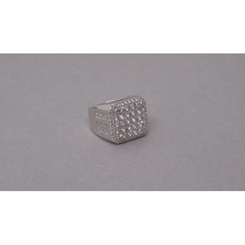 95 - A large silver checkerboard style dinner ring set with several round white cubic zirconia - ring siz... 