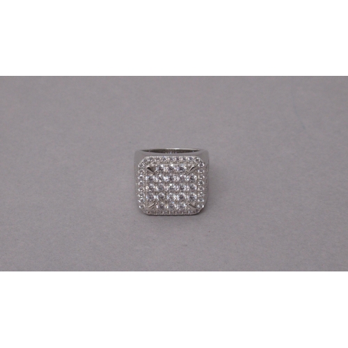 95 - A large silver checkerboard style dinner ring set with several round white cubic zirconia - ring siz... 