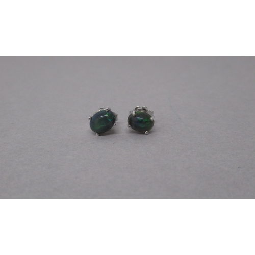 96 - A pair of oval cabochon Ethiopian black opal studs in silver