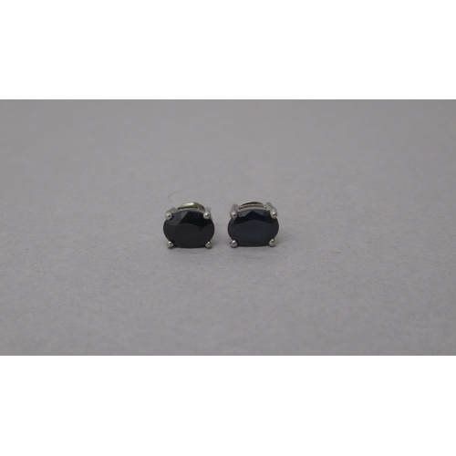 97 - A pair of treated sapphire studs in silver