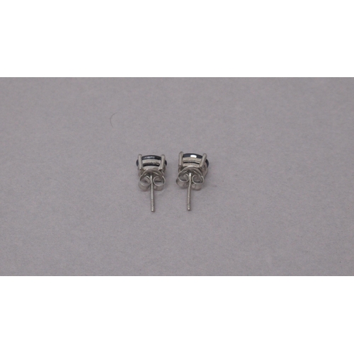 97 - A pair of treated sapphire studs in silver