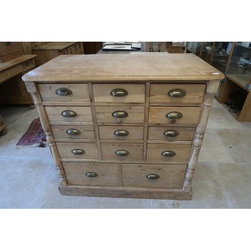 596 - A 19th century pine 14 drawer chest with brass cup handles - Width 105cm x Depth 59cm x Height 97cm