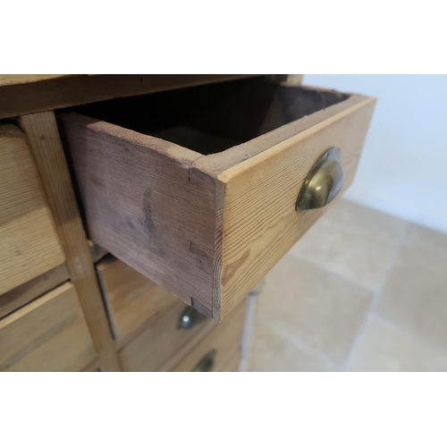 596 - A 19th century pine 14 drawer chest with brass cup handles - Width 105cm x Depth 59cm x Height 97cm