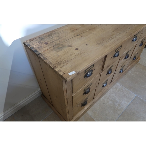 598 - A Continental pine 12 drawer chest of drawers - Width 147cm x Height 77cm