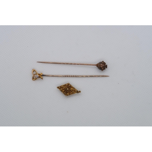 102 - Two gold tie pins, both marked 15ct one with diamond and a gold button (tested) 4 grams